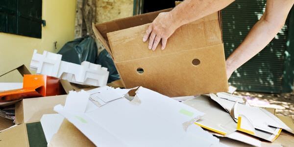 Hände sortieren Papiere und Unterlagen in einem Karton – Entrümpelung in Worms